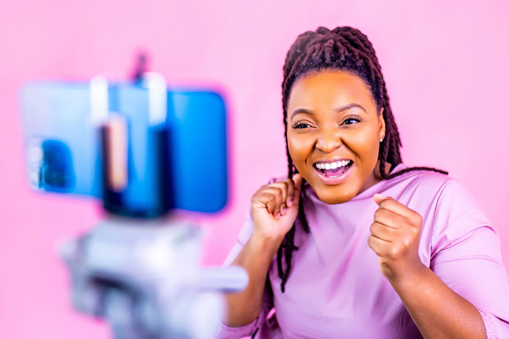 hispanic woman with cool dreadlocks pigtails wear pink dress in studio